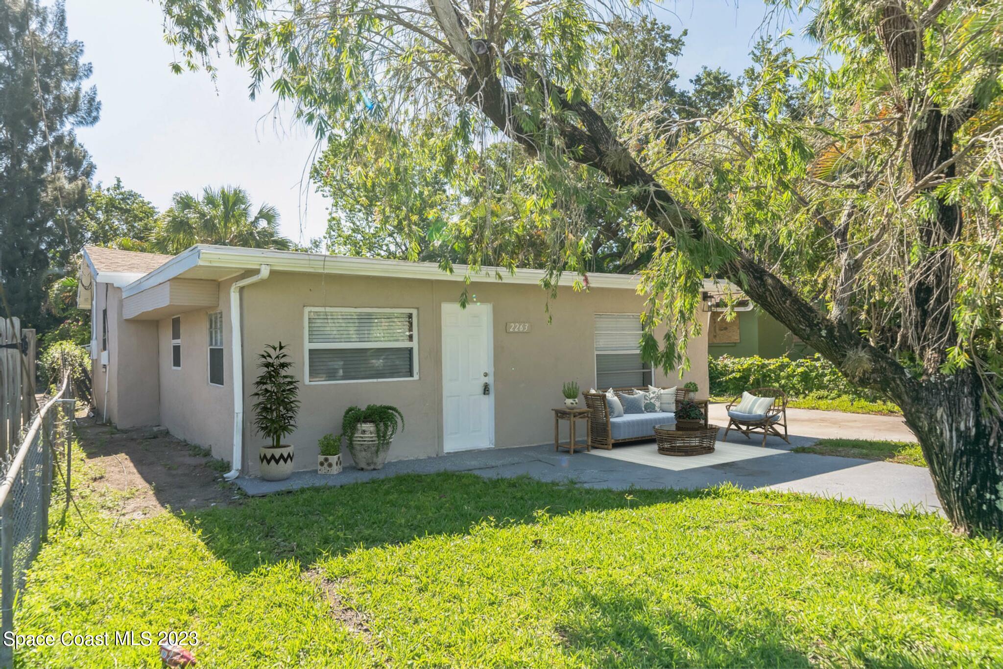 2263 Monroe Street Palm Bay, FL 32905 - Photo 1 of 13 a view of a house with backyard and sitting area