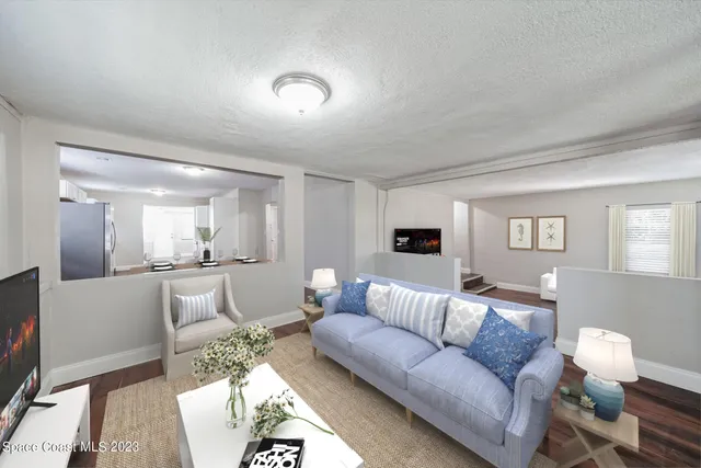 a bedroom with a bed chandelier and a window