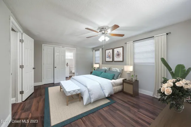 a bedroom with a bed and a potted plant