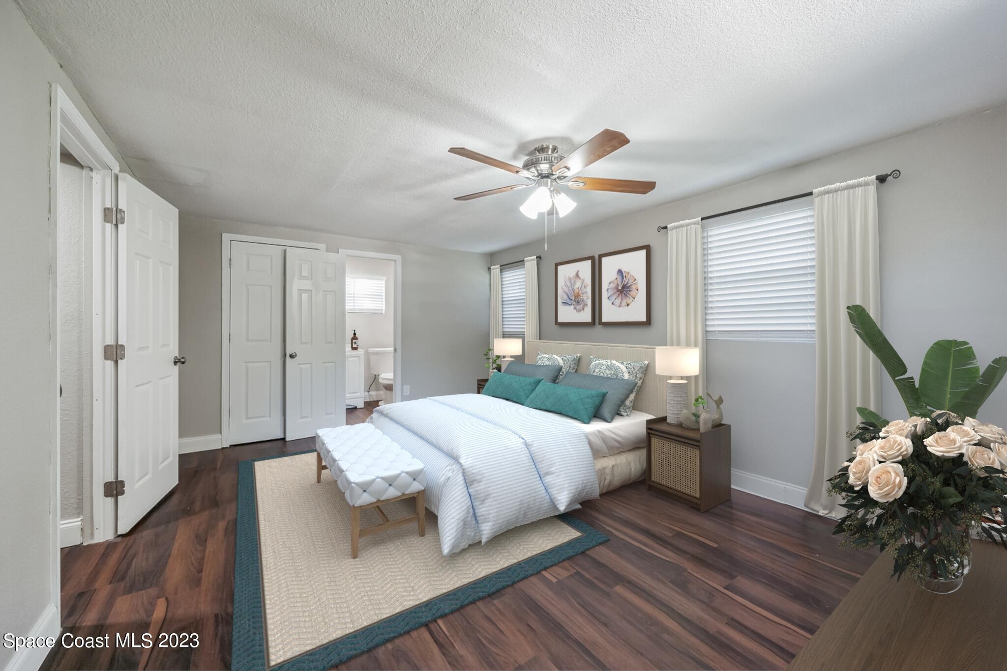 2263 Monroe Street Palm Bay, FL 32905 - Photo 9 of 13 a bedroom with a bed chandelier and a window