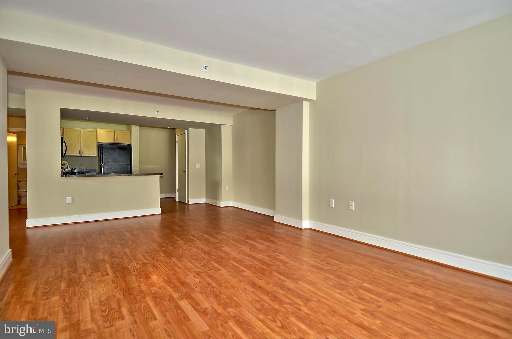 800 4th Street Southwest, Unit N201 Washington, DC 20024 - Photo 9 of 25 a view of an empty room with wooden floor and a window