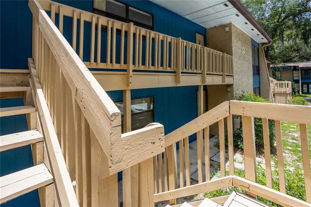 2811 Southwest Archer Road, Unit O122 Gainesville, FL 32608 - Photo 1 of 1 a view of wooden house with stairs