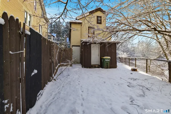a view of a house with a snow in the background