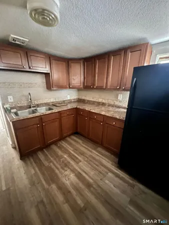 a kitchen with granite countertop sink stove and cabinets