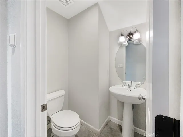 a bathroom with a sink a toilet and mirror