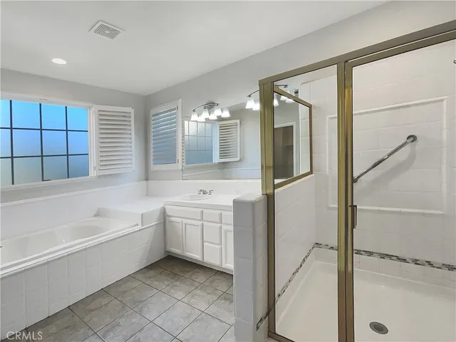 a bathroom with a bathtub sink and mirror