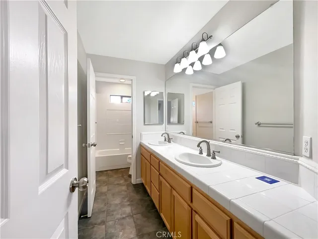 a bathroom with a double vanity sink mirror and double