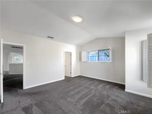 a view of an empty room and a window