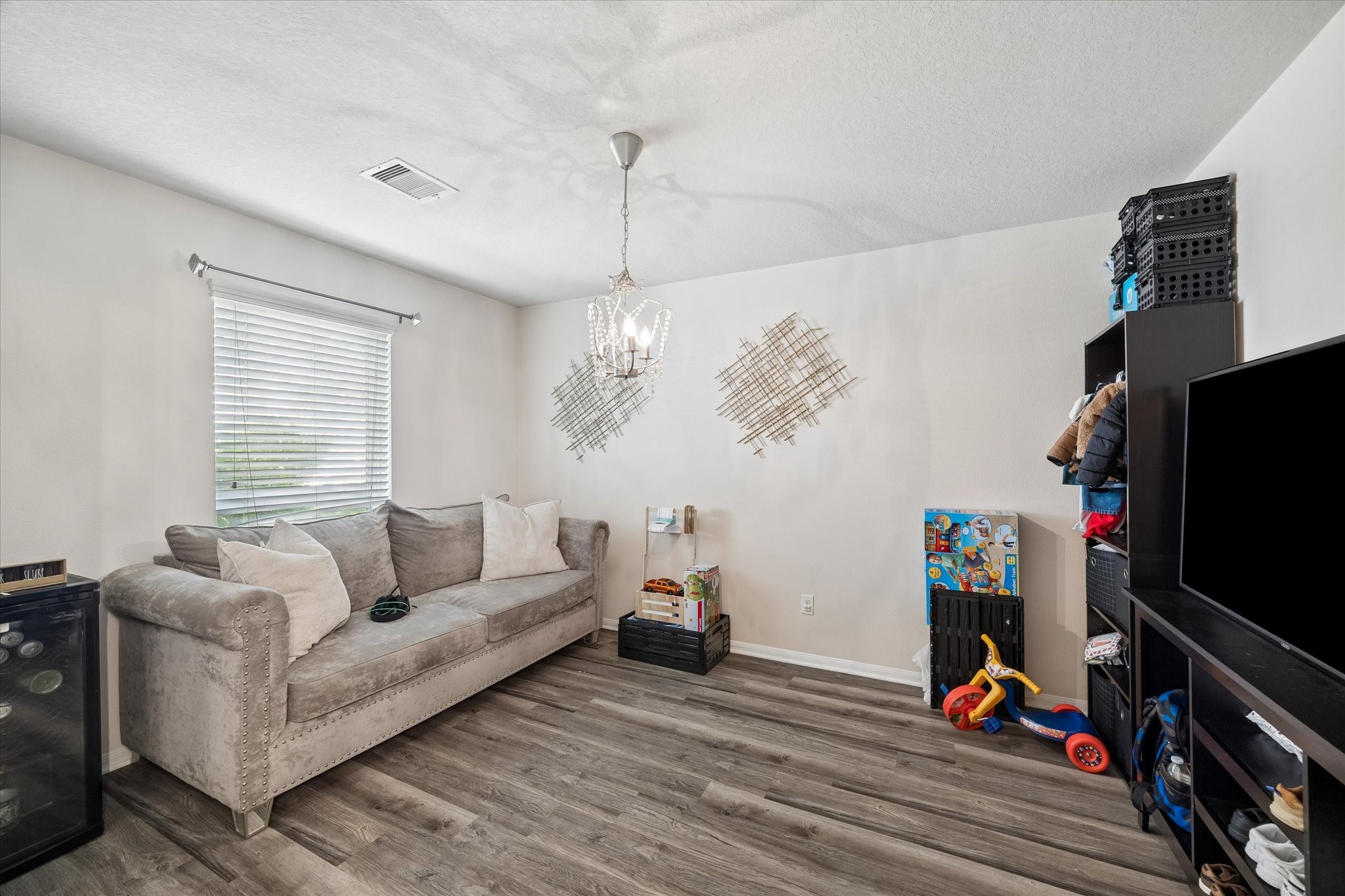 4830 Conifer Ridge Way Humble, TX 77346 - Photo 12 of 16 a living room with furniture and a flat screen tv