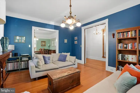 a living room with furniture and a chandelier