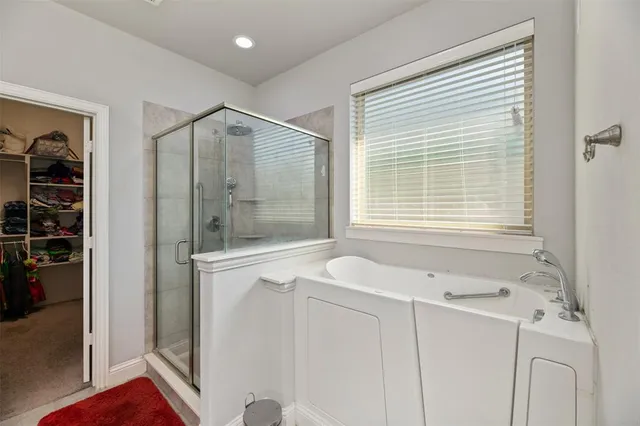 a living room with a bed and a flat screen tv