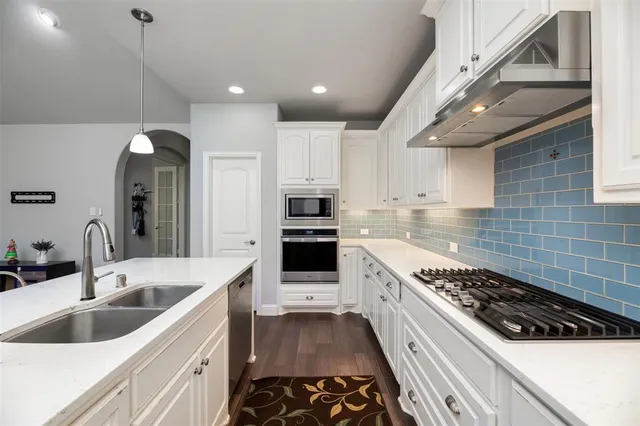 a kitchen with a sink stove and cabinets