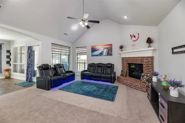 a living room with furniture fireplace and flat screen tv
