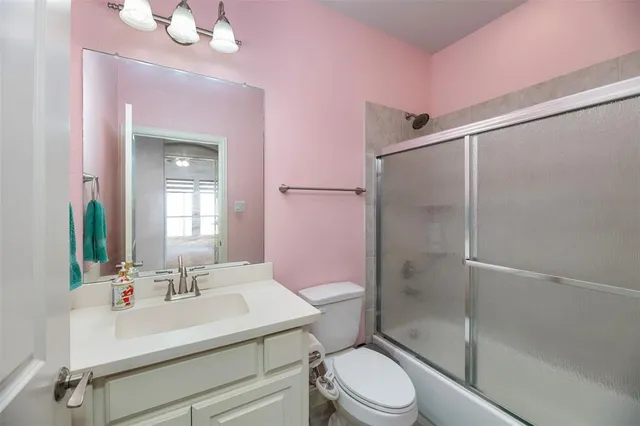a bathroom with a sink vanity mirror and toilet