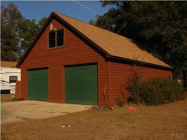 5124 Woodbine Road Pace, FL 32571 - Photo 8 of 24 3,000 square feet, two stories, 2 garage doors!! There is endless possibilities with this shop! Dont need a Shop?? A little sheetrock and a little Heat & Air and you have 3,000 square feet of additional living space for a Mother in Law Suete or Game Room.