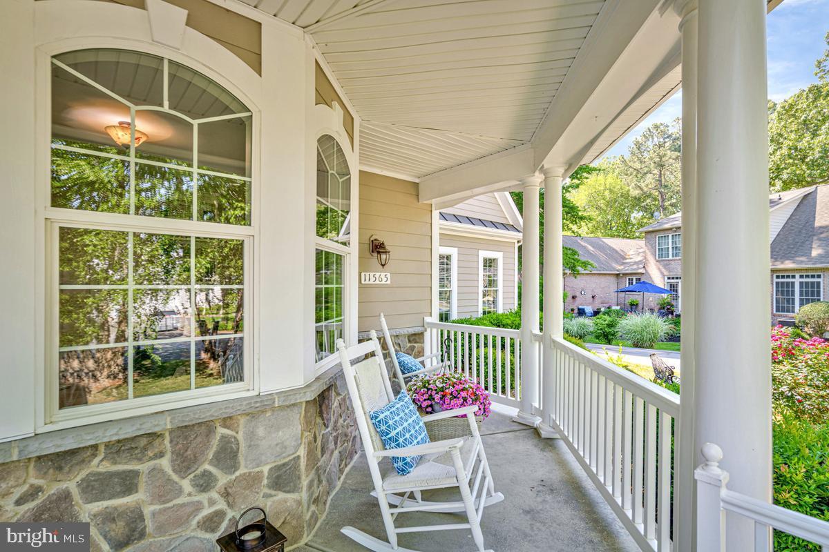 11565 Magnolia Court Issue, MD 20645 - Photo 6 of 68 a porch with a bench next to a yard