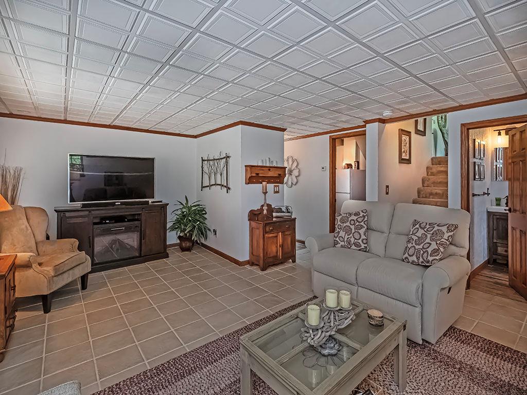 638 Knoll Lane Apollo, PA 15613 - Photo 22 of 30 a living room with furniture a flat screen tv and a table