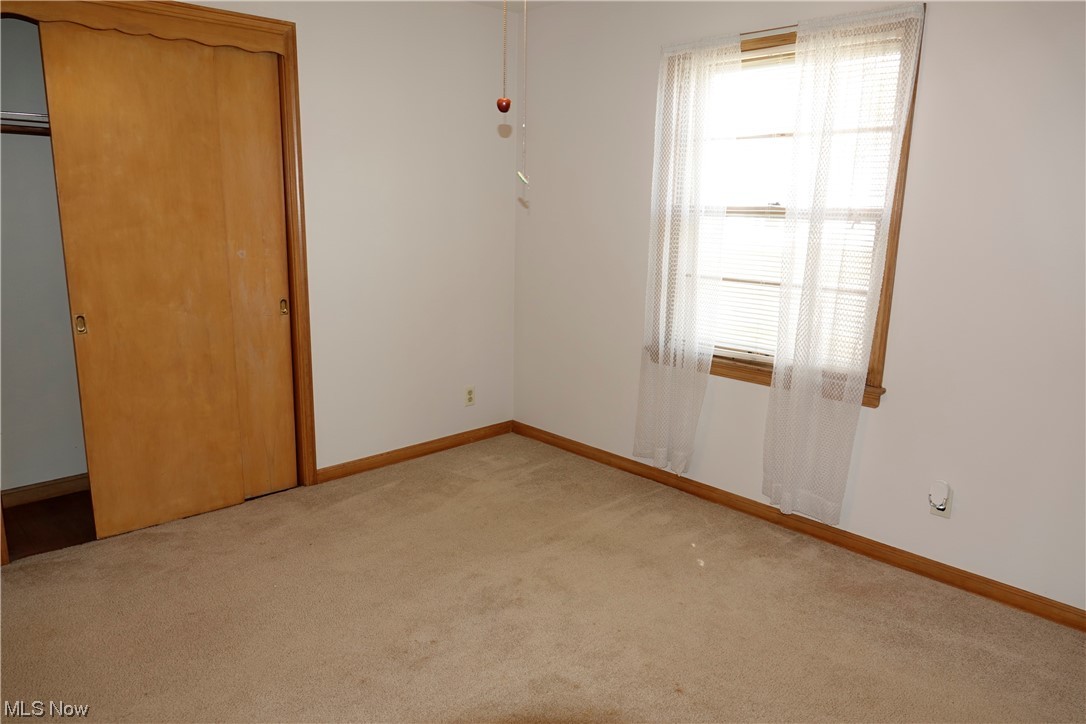 5376 Huron Road Cleveland, OH 44124 - Photo 18 of 32 Unfurnished bedroom with multiple windows, light colored carpet, and a closet