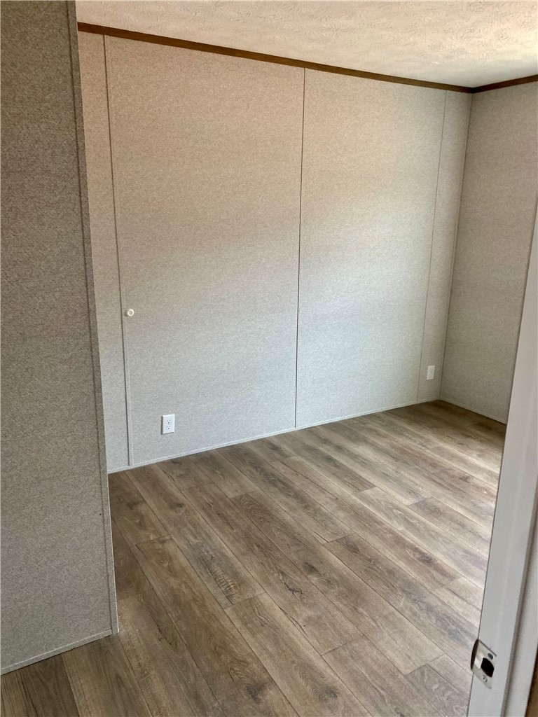 384 Skippers Lodge Road Cross Hill, SC 29332 - Photo 12 of 47 This spacious room features attractive wood flooring and ample wall space.