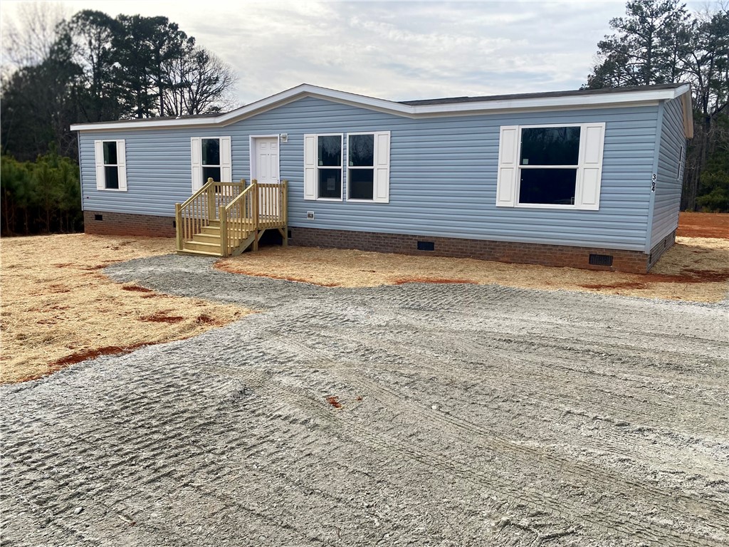 384 Skippers Lodge Road Cross Hill, SC 29332 - Photo 2 of 47 This newly constructed home features a welcoming entryway with a fresh gravel driveway.