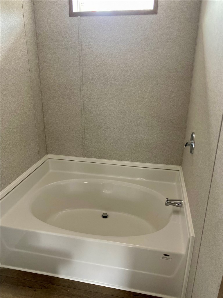 384 Skippers Lodge Road Cross Hill, SC 29332 - Photo 21 of 47 Relax in the deep soaking tub of this inviting bathroom.