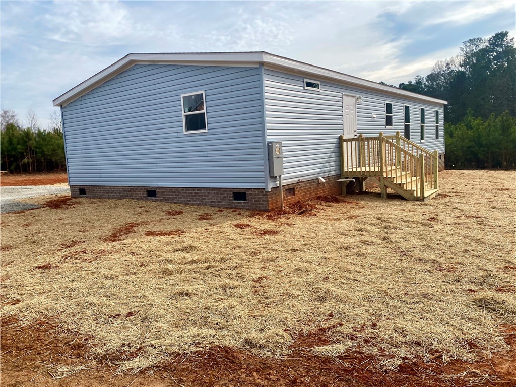 384 Skippers Lodge Road Cross Hill, SC 29332 - Photo 25 of 47 This newly constructed home features a welcoming exterior, ready for personalized landscaping.