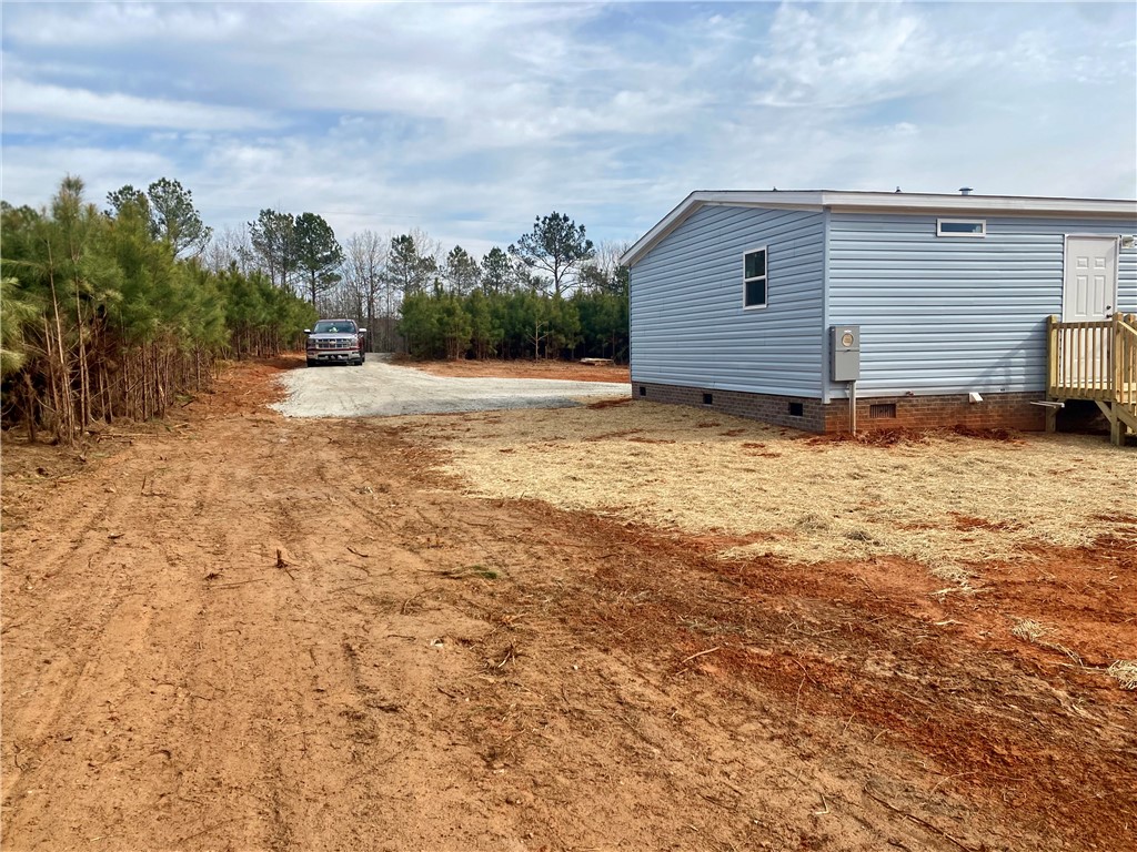 384 Skippers Lodge Road Cross Hill, SC 29332 - Photo 27 of 47 This property features new construction set against a natural, expansive backdrop.