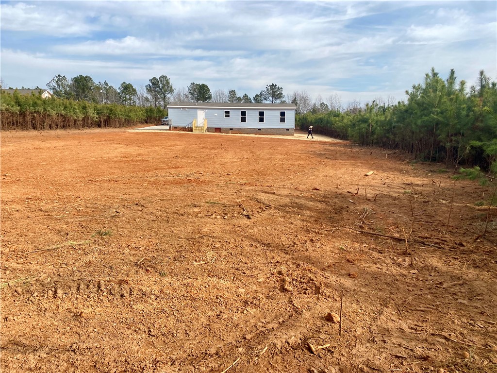 384 Skippers Lodge Road Cross Hill, SC 29332 - Photo 30 of 47 A spacious, open plot with a new home and ample room for future development.