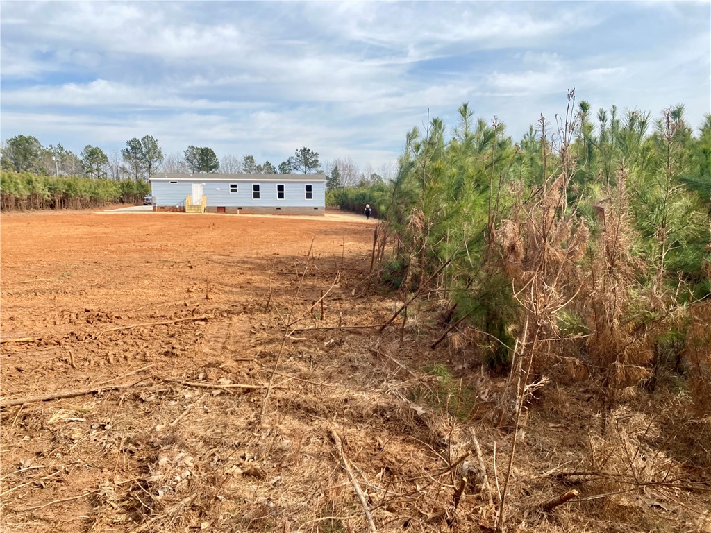 384 Skippers Lodge Road Cross Hill, SC 29332 - Photo 34 of 47 A newly constructed residence sits on a spacious, open lot, ready for personalization and landscaping.