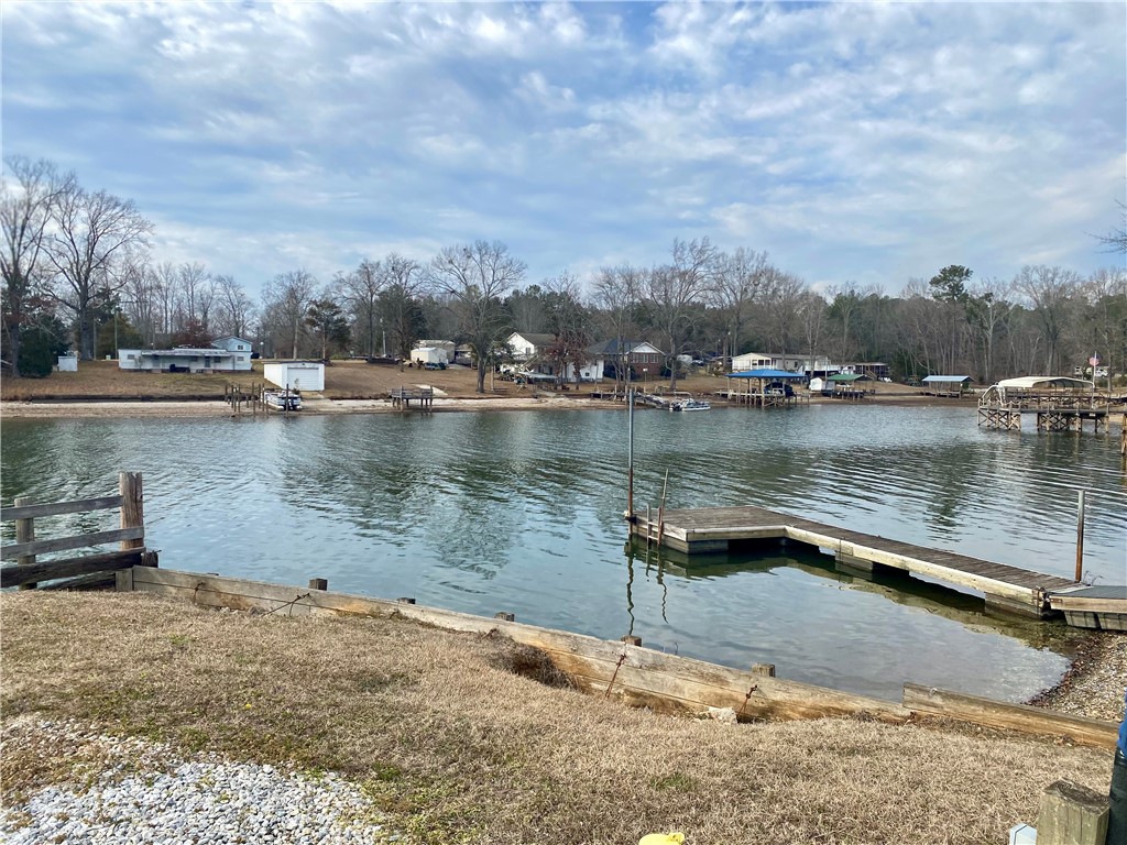 384 Skippers Lodge Road Cross Hill, SC 29332 - Photo 41 of 47 This tranquil waterfront setting features a private dock, offering direct access to scenic lake views.