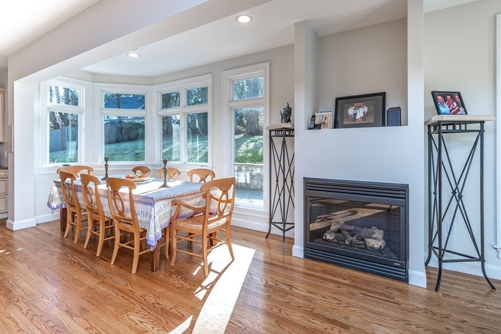 18 Fox Hill Road Newton, MA 02459 - Photo 5 of 37 a dining room with furniture a fireplace and wooden floor