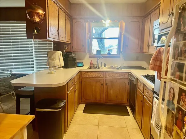 a kitchen with a sink a stove and cabinets