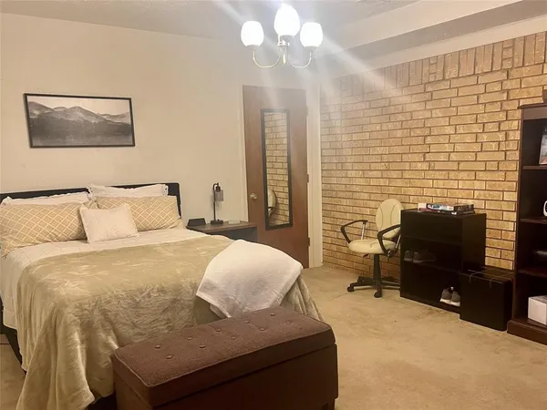 a bedroom with a bed and a desk