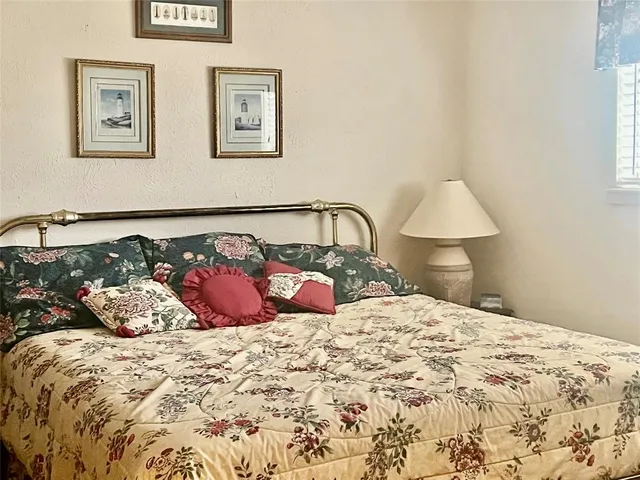 a bedroom with a bed and a lamp