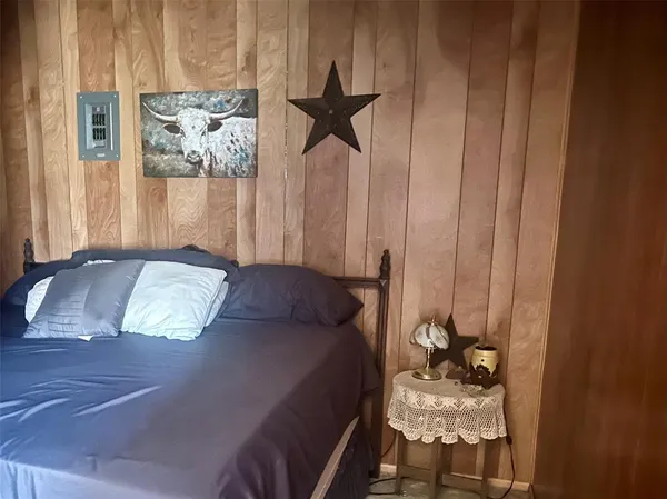 a bedroom with a bed and a chandelier