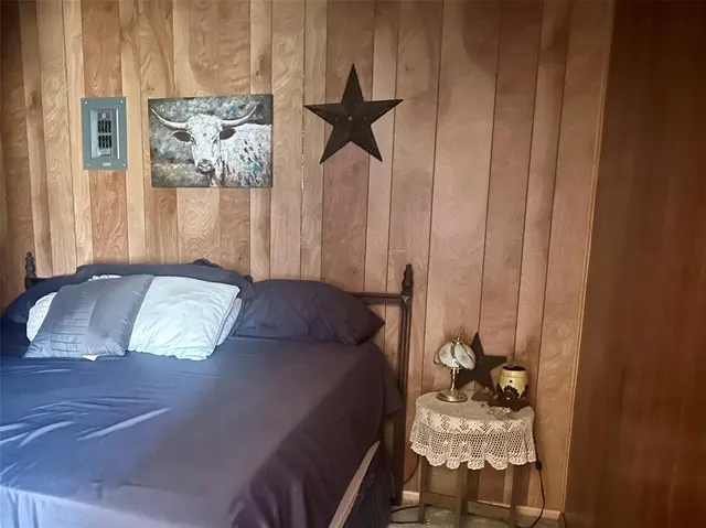 a bedroom with a bed and a chandelier