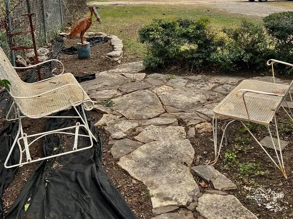 a view of a chairs and table in the patio