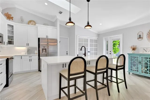 a view of a kitchen with a dining table and chairs