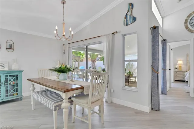 a view of a dining room with furniture and chandelier