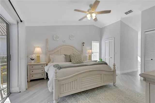 a bedroom with a bed and a ceiling fan