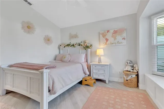 a bedroom with a bed and a baby crib with a dresser