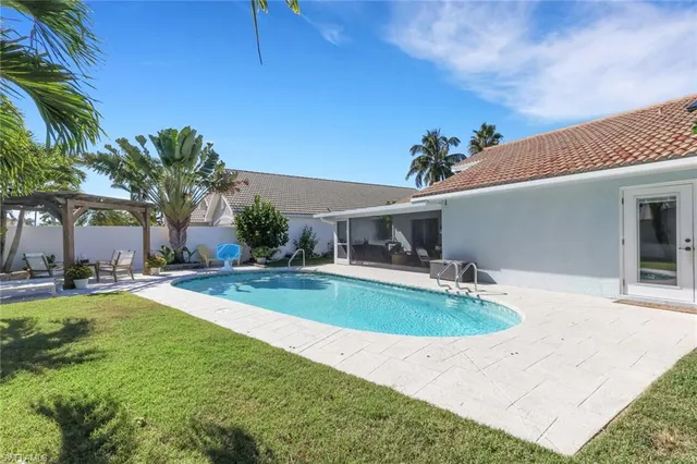 a view of a house with swimming pool and sitting area