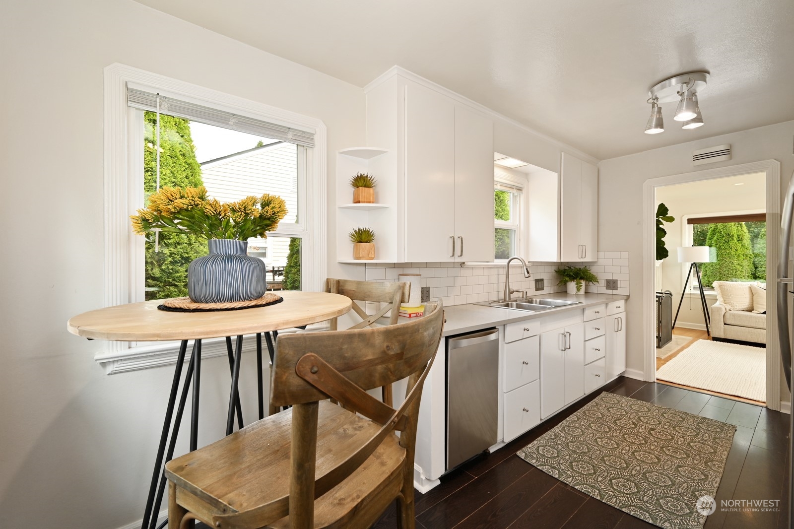 6037 Fauntleroy Way Southwest Seattle, WA 98136 - Photo 13 of 37 a living room with kitchen island granite countertop furniture a large window and a fireplace