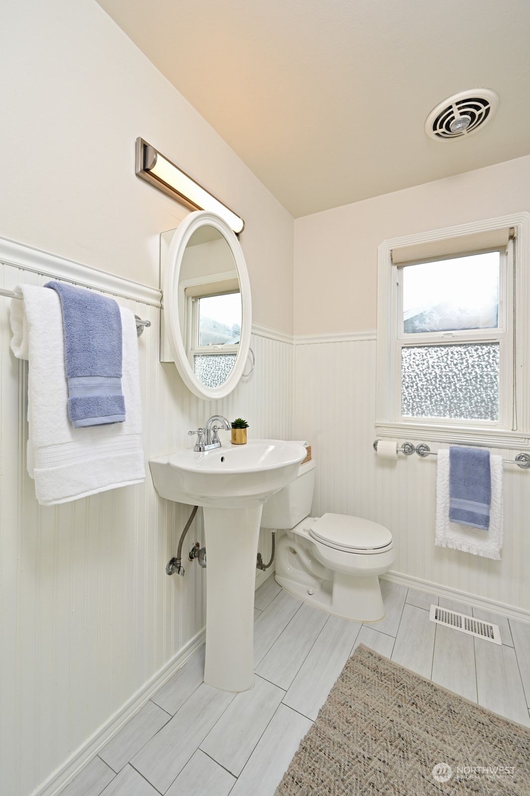 6037 Fauntleroy Way Southwest Seattle, WA 98136 - Photo 20 of 37 a bathroom with a sink toilet and a mirror