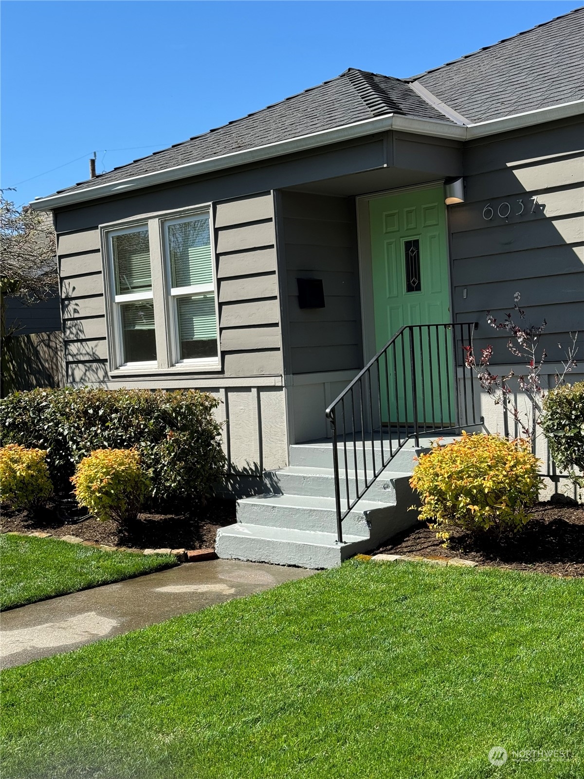 6037 Fauntleroy Way Southwest Seattle, WA 98136 - Photo 2 of 37 a front view of a house with garden