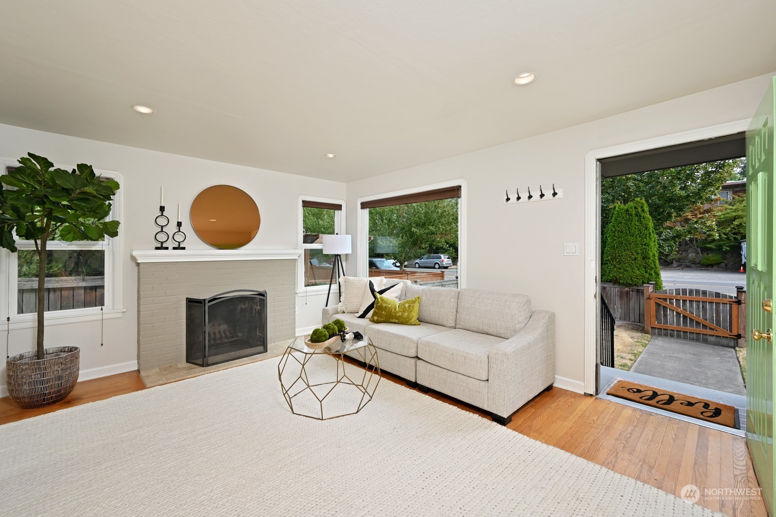 6037 Fauntleroy Way Southwest Seattle, WA 98136 - Photo 3 of 37 a living room with furniture a fireplace and a large window