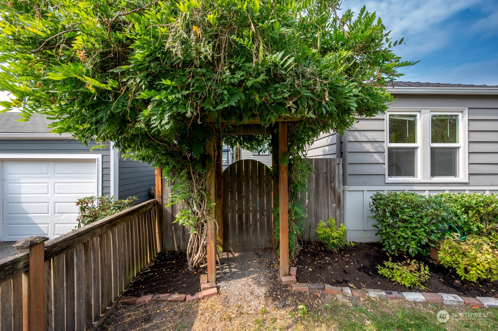 6037 Fauntleroy Way Southwest Seattle, WA 98136 - Photo 34 of 37 a view of a house with a tree in the background