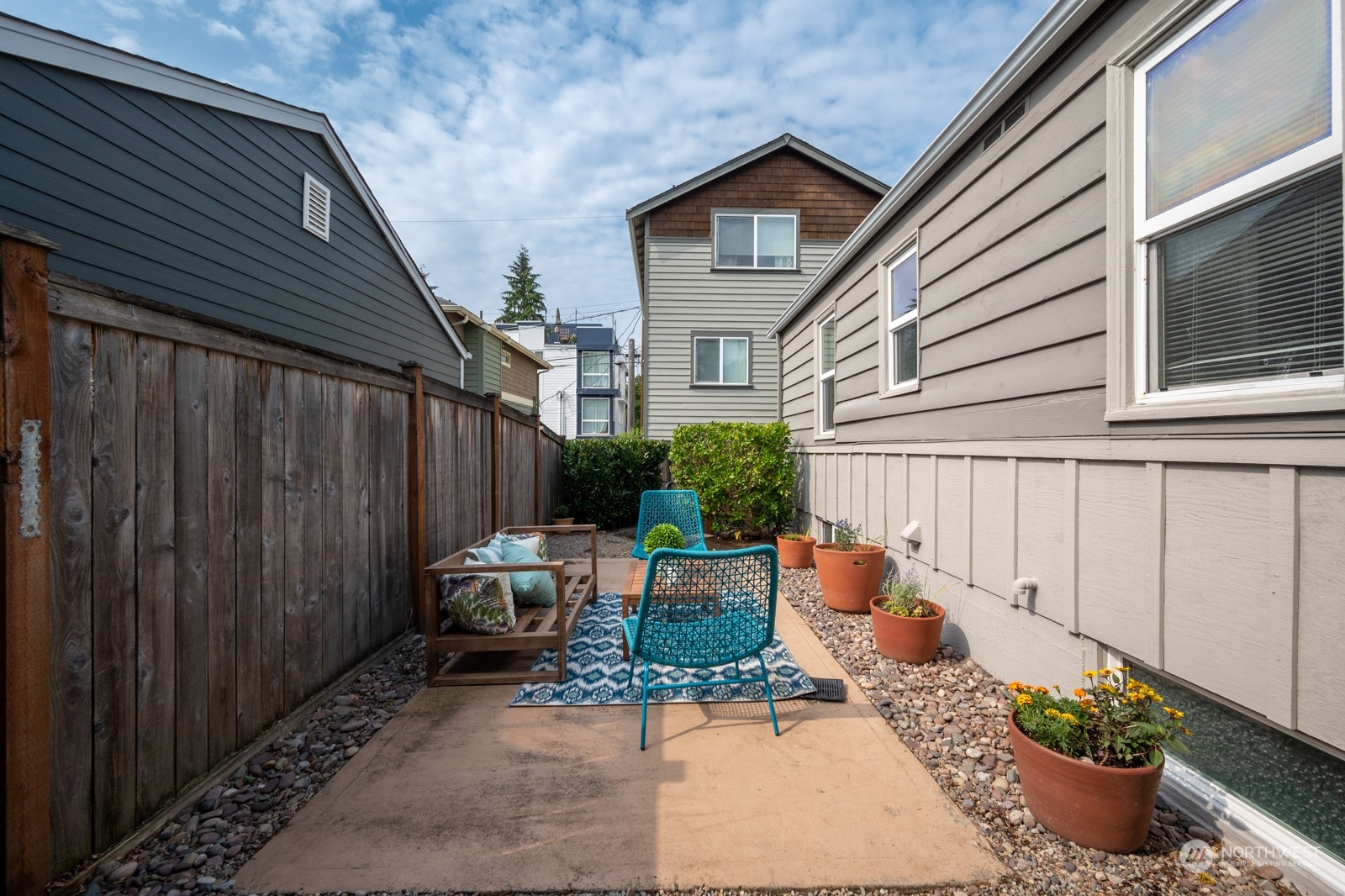 6037 Fauntleroy Way Southwest Seattle, WA 98136 - Photo 35 of 37 a backyard of a house with a potted plant and outdoor seating
