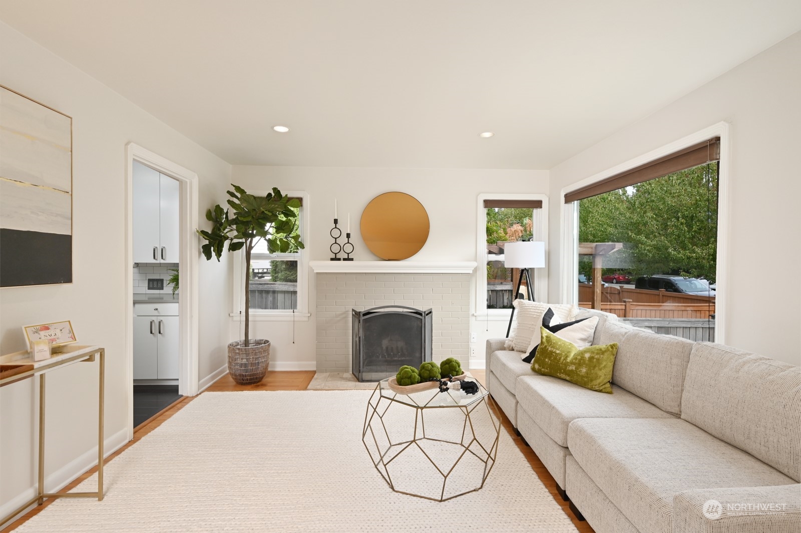 6037 Fauntleroy Way Southwest Seattle, WA 98136 - Photo 5 of 37 a living room with furniture a fireplace and a floor to ceiling window