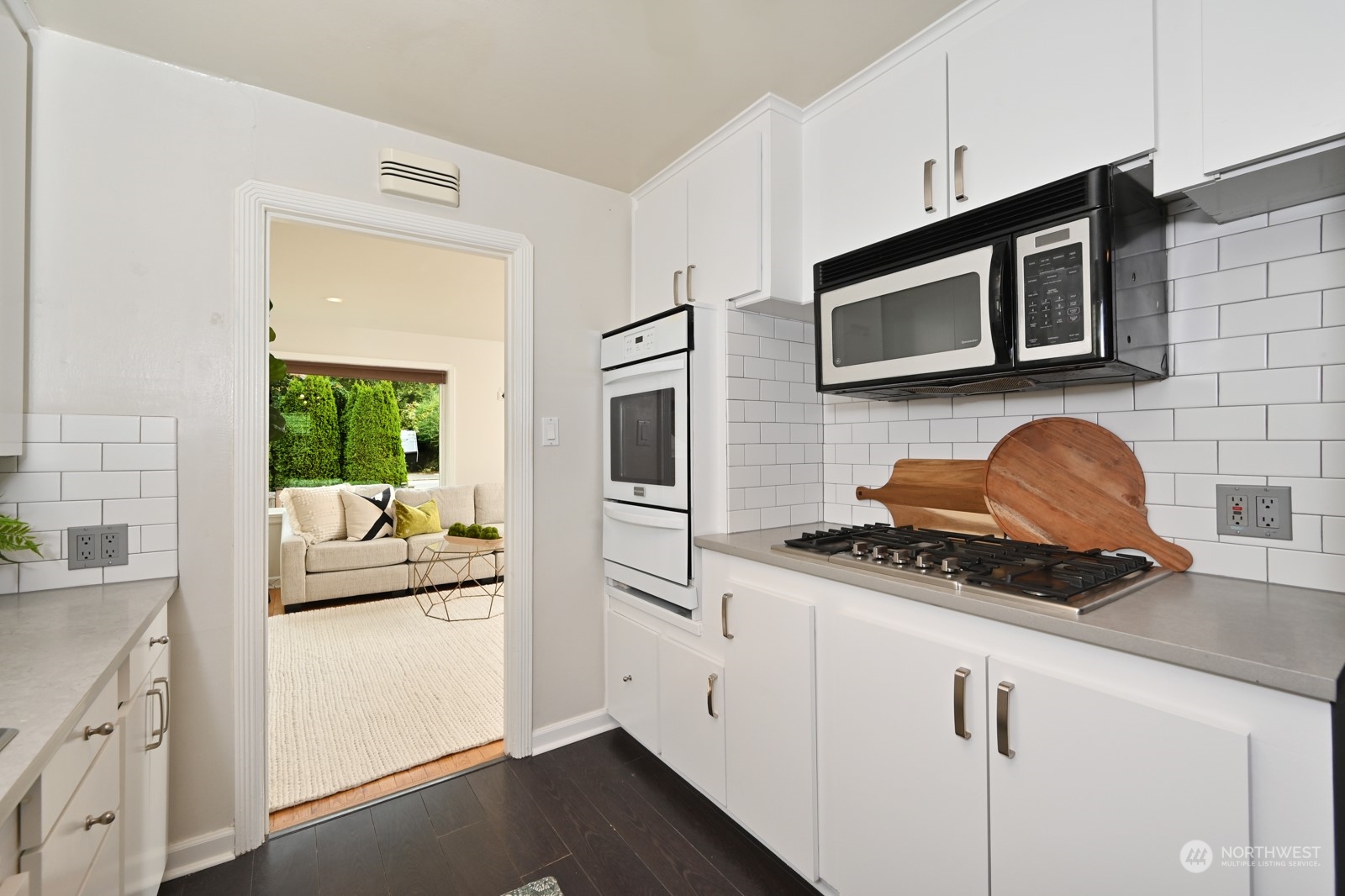 6037 Fauntleroy Way Southwest Seattle, WA 98136 - Photo 8 of 37 a kitchen with stainless steel appliances granite countertop a stove and a microwave